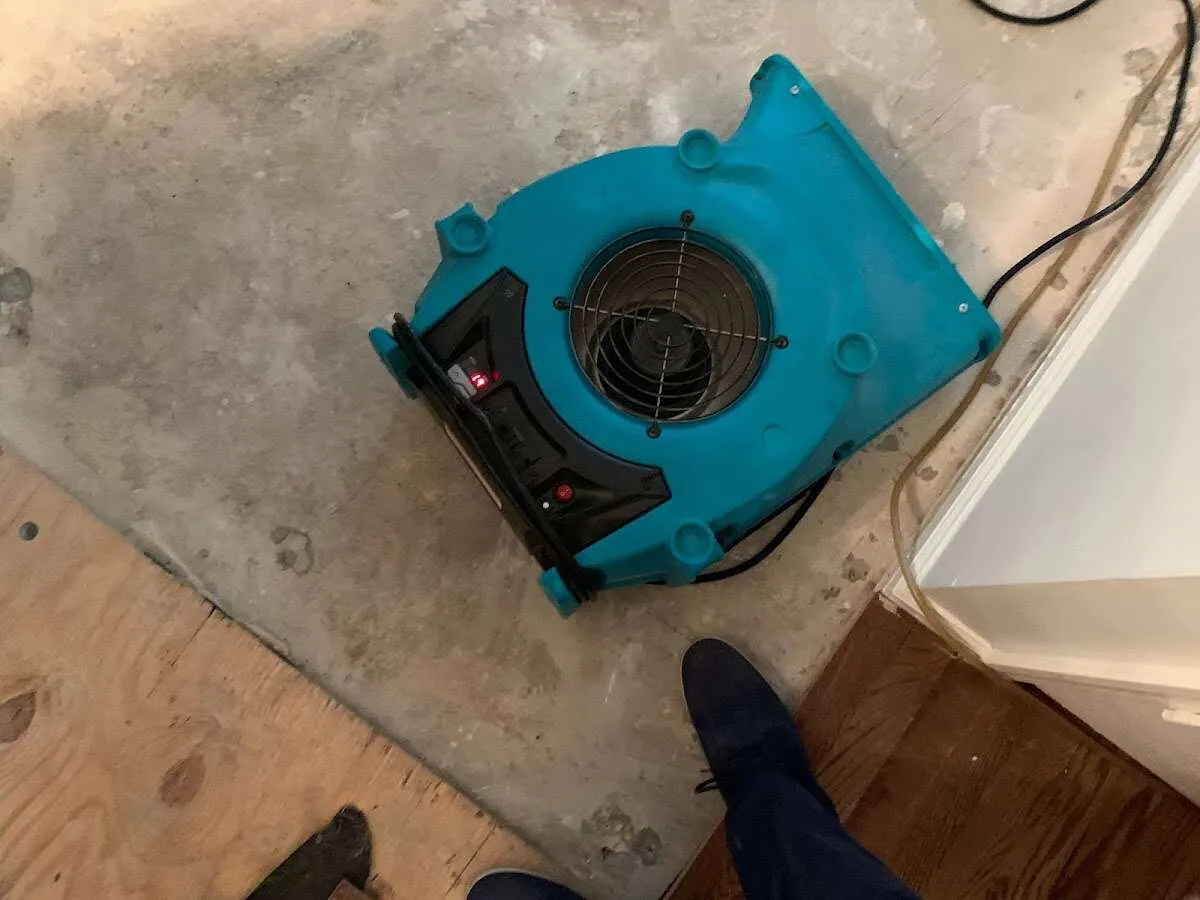 Air mover drying subfloor during Commercial Water Damage Restoration in Las Vegas